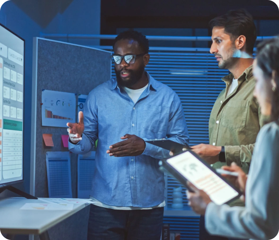 Team discussing presentation in modern office setting.